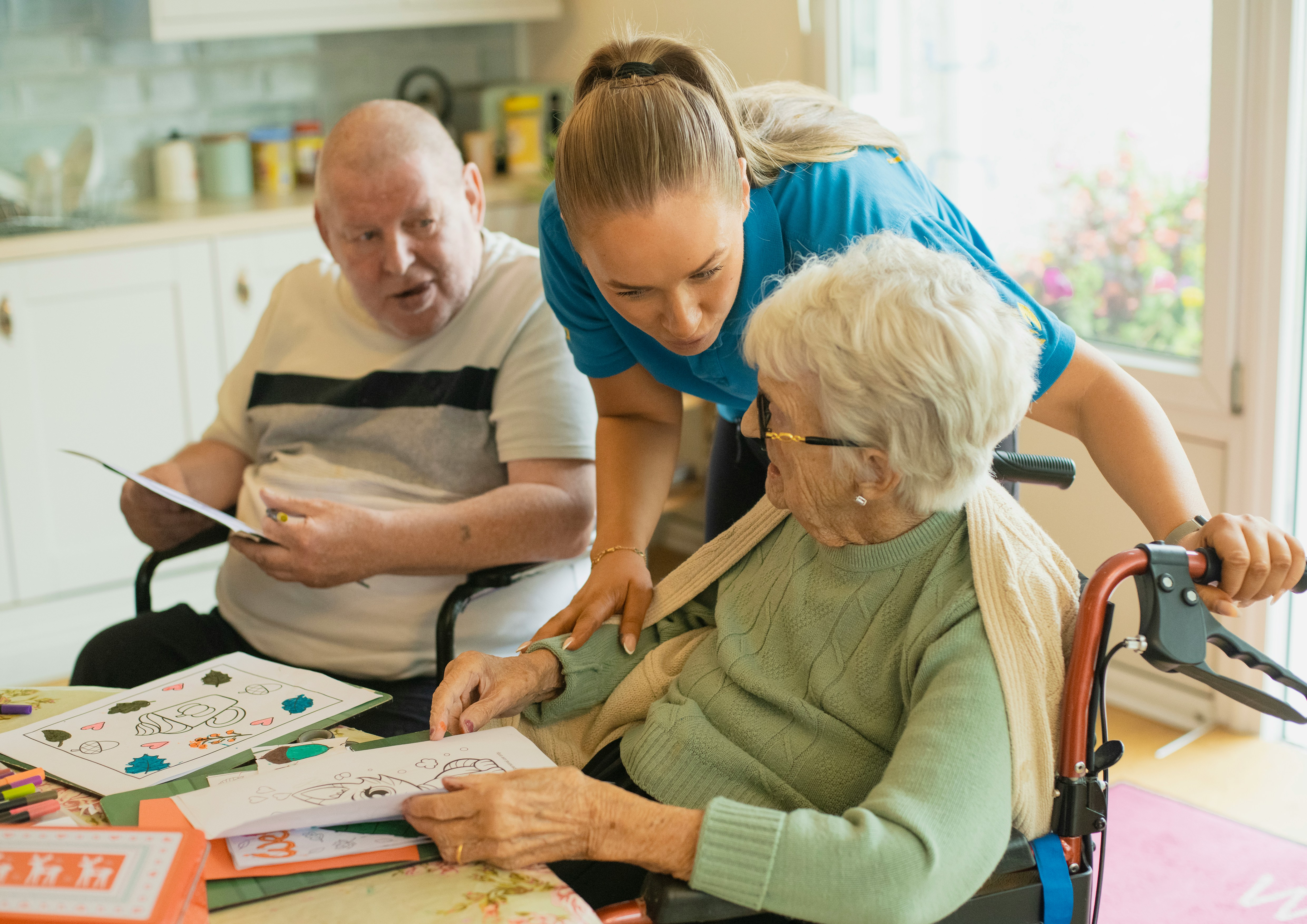 Placeholder: a support worker sharing a cup of tea with a client at home